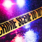 7 Dead As Family Breakfast Turns Into Bloodbath Crime scene tape with flashing lights in background.