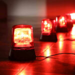 Near-Massacre Stopped — But Barely Red emergency lights on dark floor, illuminating the area.