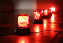 Near-Massacre Stopped — But Barely Red emergency lights on dark floor, illuminating the area.