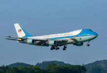 Foreign Gift Fuels Air Force One Uproar Airplane flying above trees with blue sky background