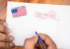 Trump Jolt Scrambles Georgia Hands addressing an official election mail envelope