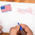Trump Jolt Scrambles Georgia Hands addressing an official election mail envelope