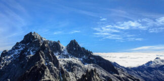 Snowy mountain peaks under clear blue sky.
