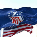 NFL Star’s Shocking Diagnosis Stuns Fans NFL flag waving in front of American flag.