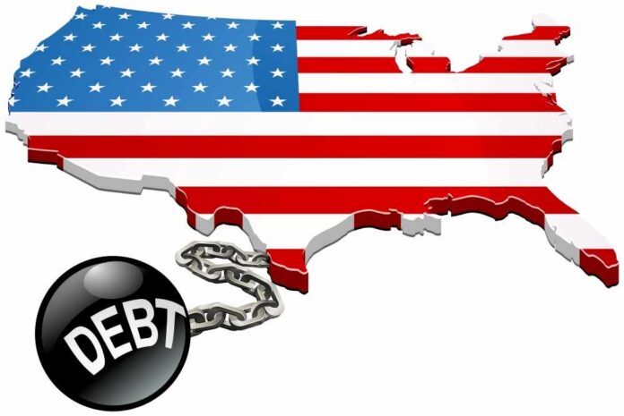 shutterstock_2135773885 Map of the USA with an American flag design and a ball and chain labeled 'DEBT'