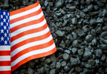 Trump’s $700M Coal Energy News Shocker US flag on pile of dark coal rocks