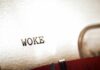 Woke Politics Charge Hits Iconic American Brand Close-up of the word WOKE typed on paper from a typewriter