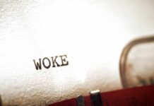 Woke Politics Charge Hits Iconic American Brand Close-up of the word WOKE typed on paper from a typewriter