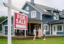 Congress Slams Wall Street Home Grabs For sale sign in front of a house with potential buyers discussing