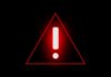 Red warning triangle with exclamation mark on black background