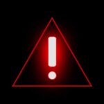 Red warning triangle with exclamation mark on black background