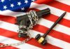 Supreme Court Shocks Hawaii Gun Rules A handgun chained on an American flag with a gavel beside it