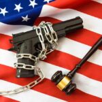 Supreme Court Shocks Hawaii Gun Rules A handgun chained on an American flag with a gavel beside it