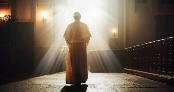 Person in religious attire bathed in sunlight.