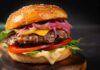 Backyard Burger Becomes A Tax? Close-up of a gourmet cheeseburger with lettuce, tomato, and pickled onions