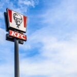 Sauce Tsunami Hits KFC KFC restaurant sign against a blue sky