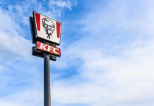 Sauce Tsunami Hits KFC KFC restaurant sign against a blue sky