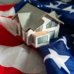 Wall Street Landlords Hit With Million-Dollar Traps A model house placed on an American flag