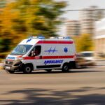 VIDEO: Hospital Turns War Zone — Deadly Shooting Ambulance van with flashing lights speeding through a city street