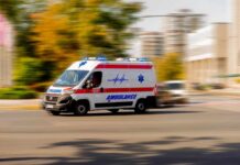 VIDEO: Hospital Turns War Zone — Deadly Shooting Ambulance van with flashing lights speeding through a city street