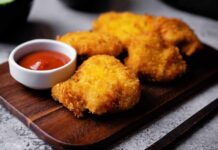 Crispy fried chicken pieces served with a small bowl of ketchup