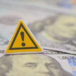Streaming Shake-Up: $22B Power Grab A warning sign placed on top of U.S. dollar bills