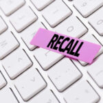Gruesome Recall Hits Amazon Product A pink sticky note with the word 'RECALL' placed on a white keyboard