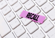 Gruesome Recall Hits Amazon Product A pink sticky note with the word 'RECALL' placed on a white keyboard