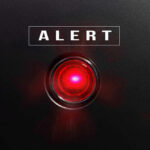 Midnight Hit Takes Out A Gang Kingpin Red alert light against black background, text ALERT.