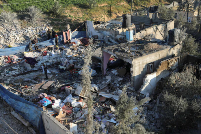 ihost People inspecting rubble and debris of destroyed buildings.