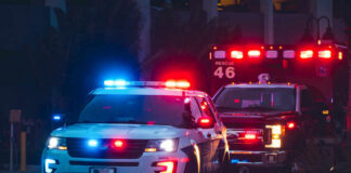 Police car and ambulance with flashing lights nighttime