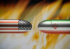 Bullets painted with U.S. and Iran flags face each other amid flames