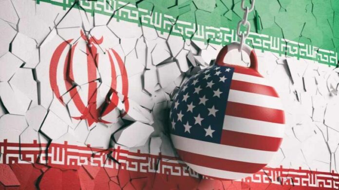 shutterstock_1164296512 A wrecking ball painted with the American flag is breaking through a wall featuring the Iranian flag