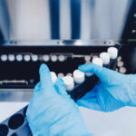 DNA Bombshell Nails Texas Mom Person in blue gloves handling test tubes in a laboratory