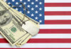 War Burn Rate STUNS Congress A stack of dollar bills on an American flag with a military dog tag