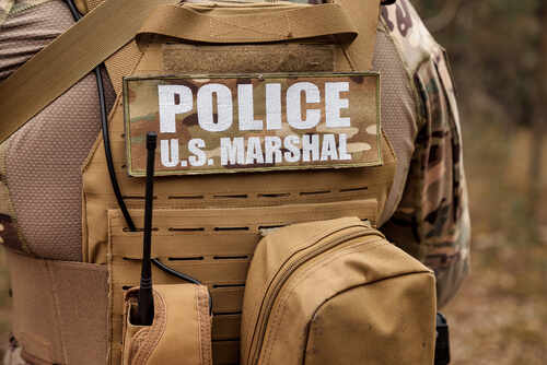 Adult,War,Team,Games,With,Weapons,,Airsoft,Or,Strikeball,,In US Marshal tactical vest