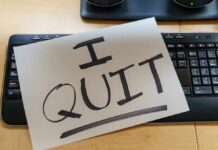 Unemployment Dips, Because Workers Quit! A resignation letter reading 'I QUIT' placed on a keyboard