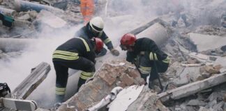 Rescue workers search rubble at a disaster site