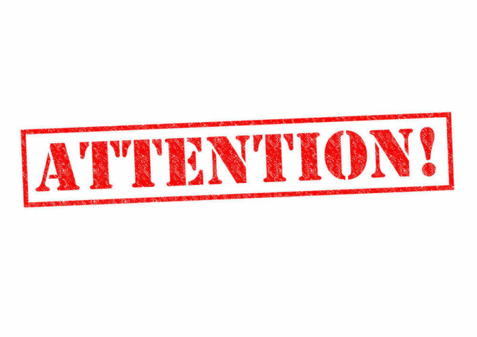 shutterstock_214851508 Red attention stamp on white background