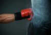 Boxing Pro Killed — Driver Reverses Back Boxers gloved hand punching a heavy bag.
