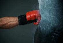 Boxing Pro Killed — Driver Reverses Back Boxers gloved hand punching a heavy bag.
