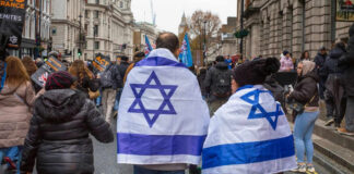 People wearing Israeli flags at a street protest