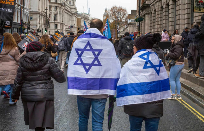 People wearing Israeli flags at a street protest