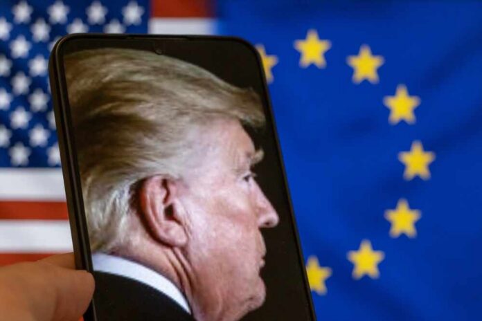 Warsaw,,Poland,-,September,17,,2025:,A,Close-up,Of,Donald Profile view of a man displayed on a smartphone in front of American and European flags