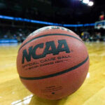 FBI Raid Upends College Hoops Star Close-up of NCAA basketball on court.