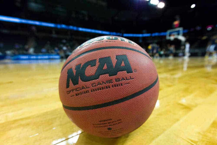 shutterstock_396222481-1 Close-up of NCAA basketball on court.