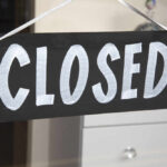 Corporate Axe Falls On DQ — Dozens Go Dark A black sign with the word 'CLOSED' painted in white letters
