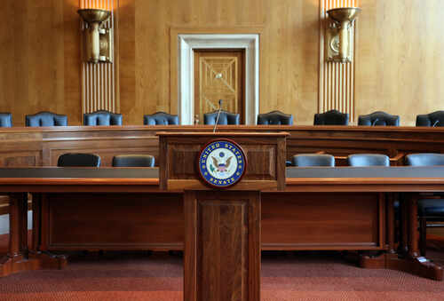 Washington,-,July,18:,A,United,States,Senate,Committee,Hearing Empty Senate chamber with a wooden podium and chairs