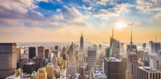 City skyline with skyscrapers at sunset.