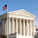 Supreme Showdown: AR-15 Bans On Trial U.S. Supreme Court building with American flag.